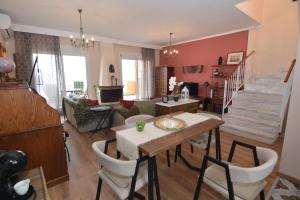 a living room with a table and chairs at Apricot House in Kavála