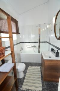a bathroom with a toilet and a tub and a sink at Apricot House in Kavála +26 photos