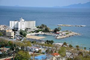 a city with a harbor and a large building at Apricot House in Kavála
