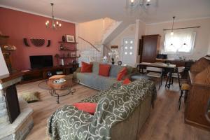 a living room with a couch and a table at Apricot House in Kavála
