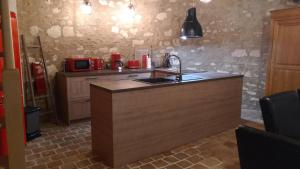 a kitchen with a sink and a counter top at La tour du logis in Chéneché