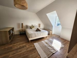 a bedroom with a white bed and a window at Villa Marine, Jacuzzi, 25' Disneyland in La Celle-sur-Morin