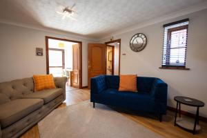 a living room with a couch and a blue chair at Eastwood in Colchester