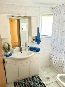 a bathroom with a sink and a mirror at SokratesVilla in Mystras +26 photos
