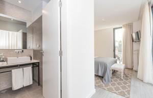 a bathroom with a sink and a shower at Estoril Village Guest House in Estoril +66 photos