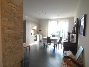 a living room with a kitchen and a dining room at La casa dei nonni in Monforte dʼAlba