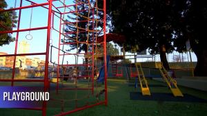 a playground with a slide in a park at Espaço para você in Ribeirão Preto