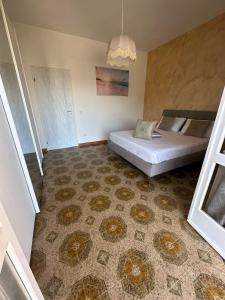 a bedroom with a bed and a rug at Greta Apartment Tropea in Tropea