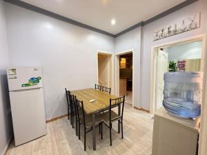 a kitchen and dining room with a table and a fish tank at شرفة أحد Suite in Medina