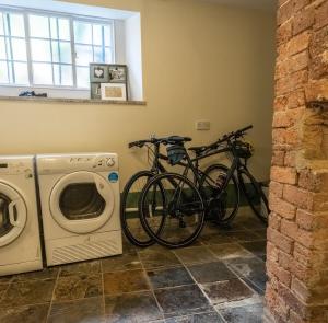 two bikes are parked next to a washing machine at Wirksworth Townhouse - full of character in Wirksworth +7 photos