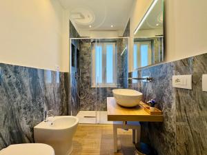 a bathroom with a sink and a toilet and a shower at YourHome - Il Pino Rooms & Apartment in Meta +28 photos