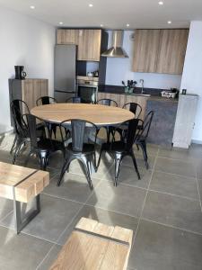 a dining room with a table and chairs and a kitchen at Triplex in Albiez-Montrond - 4 Bedrooms in Albiez-Montrond