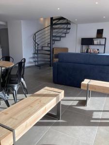 a living room with a blue couch and tables at Triplex in Albiez-Montrond - 4 Bedrooms in Albiez-Montrond +10 photos