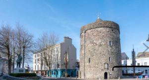 a tall stone tower on a city street at Viking triangle in Waterford