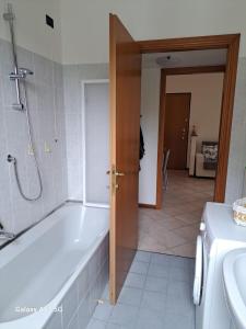a bathroom with a bath tub next to a sink at CasaElvi Milano vicino IEO in Milan