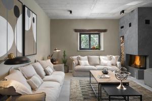 a living room with a couch and a fireplace at Luxury Villa Covri in Brtonigla