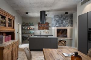 a kitchen with a wooden table and a stove at Luxury Villa Covri in Brtonigla