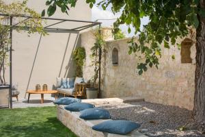 a patio with blue pillows on a stone bench at Luxury Villa Covri in Brtonigla