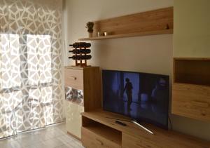 a living room with a large flat screen tv at Casa Alice in Milano Parco Nord in Bresso