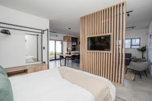 a bedroom with a bed and a living room at Studio 56 in Langebaan