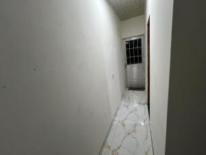 a room with white walls and a marble floor at Eri House Home in Ananindeua