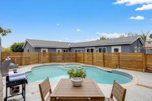 a swimming pool in a backyard with a wooden fence at Studio 3 Min to Downtown Beaches Freeways Airport in San Diego