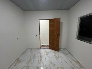 an empty room with a door and a mirror at Eri House Home in Ananindeua