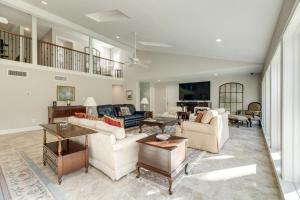 a large living room with couches and tables at Stunning Waterfront Rental Property with Private Dock and Pool in Dickinson