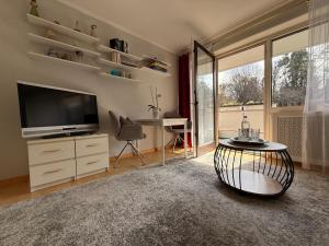a living room with a television and a table at Ferienwohnung Thurner in Bad Reichenhall