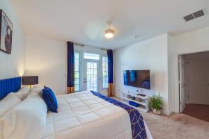 a bedroom with a large bed and a tv at 3 Mi to Beach: Ocean View Getaway w/ Pool Access in Ocean View +27 photos
