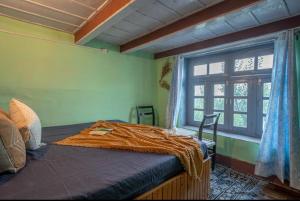 a bedroom with a large bed with a window at Mountain eyrie in Banjār +17 photos