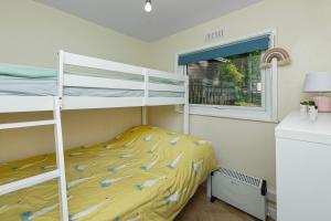 a bedroom with two bunk beds and a window at Finest Retreats - Lindisview in Caernarfon