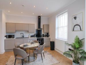 Una cocina y un comedor con mesa y sillas. en The Salisbury - 1 Bedroom Deluxe Apartment, en Scarborough 17 fotos más
