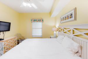 a bedroom with a bed and a flat screen tv at Majestic Sun B0206 in Destin