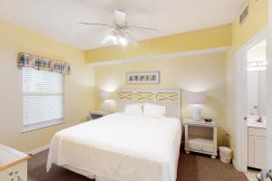 a bedroom with a white bed and a ceiling fan at Majestic Sun B0206 in Destin +15 photos