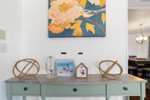 a table in a room with a painting on the wall at Oversized Family Beach Block Duplex with Game Room in Atlantic City