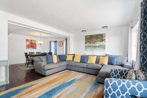 a living room with a couch and a table at Oversized Family Beach Block Duplex with Game Room in Atlantic City