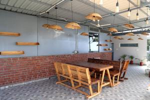 a dining room with a wooden table and chairs at ALPINE BNB Dharmshala Homestay in Dharamshala