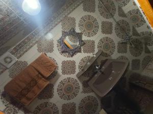 a bathroom with a sink and a mirror at Riad lala Drissia in Gare de Tanger-Fès +38 photos