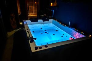 a large swimming pool in a dark room at Spassionnement in Le Passage