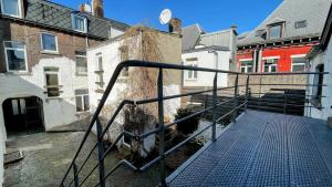 a stairway leading to a building with buildings at La Cachette d 'Amercoeur in Liège +5 photos
