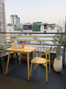 a table and chair on a balcony with a view at Papaya hotel in Ho Chi Minh City