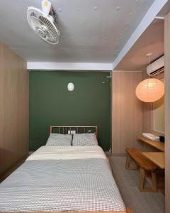a bedroom with a large bed with a green wall at Papaya hotel in Ho Chi Minh City +53 photos