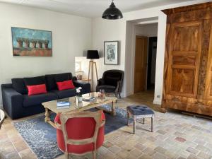 a living room with a couch and a table at La Maison des Belles Filles in Pernand-Vergelesses