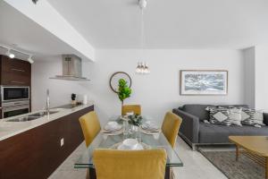 a kitchen and living room with a table and a couch at Luxury Miami Condo with Breathtaking City & Bay Views in Miami