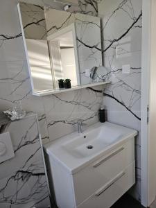 a bathroom with a sink and a mirror at Apartman NOA in Slavonski Brod +34 photos