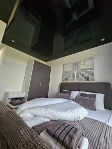 a bedroom with two beds and a painting on the wall at Apartman NOA in Slavonski Brod