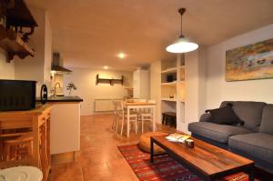 a living room with a couch and a table at Casa Rural Finca Buenavista in Valdeganga de Cuenca