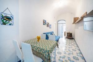 a dining room with a table and a couch at Villa Gianna "Nonna Gianna's Home Amalfi Coast" in Conca dei Marini