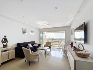 a living room with a couch and a table at Port Grec 3 - Piso vista al puerto y montana in Empuriabrava